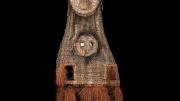 A double faced, tall woven dance mask from Kanganaman Village. The mask has two hand holes, a raffia skirt, and two holes in the lower face for the dancer to see out. Front View.